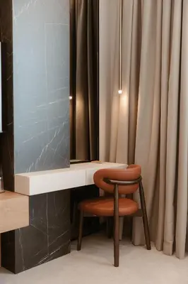 a dressing table with a stool and a mirror at Tradicija Hotel in Banja Luka
