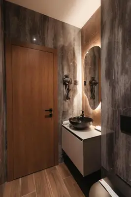 a bathroom with a sink and a wooden door at Tradicija Hotel in Banja Luka