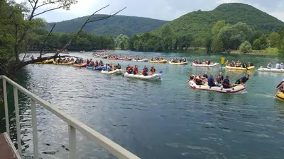 a group of people in boats on a river at Zem Zem kuća za odmor in Otoka