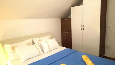 a bedroom with a bed with a blue blanket and white pillows at Zem Zem kuća za odmor in Otoka
