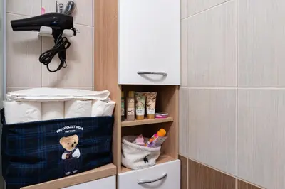 a bathroom with a shelf with items in it at Apartman Haba Vlašić in Vlasic