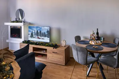 a living room with a table and a television at Apartman Haba Vlašić in Vlasic