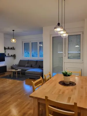 a living room with a table and a couch at Green view apartment in Banja Luka