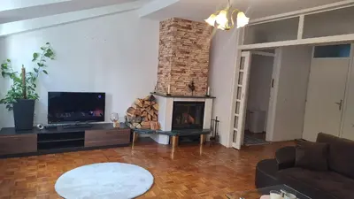 a living room with a fireplace and a tv at Atika in Cazin