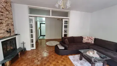 a living room with a couch and a fireplace at Atika in Cazin