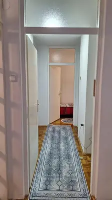 a room with a hallway with a rug on the floor at Atika in Cazin