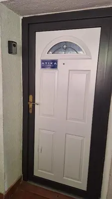 a white door with a sign on it at Atika in Cazin