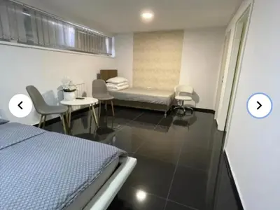 a hospital room with a bed and a table and chairs at EM Apartments in Tuzla
