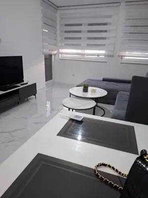 a living room with a couch and a table at Apartman Ditka in Bihać