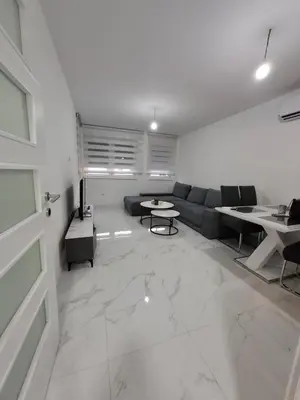 a living room with a couch and a table at Apartman Ditka in Bihać
