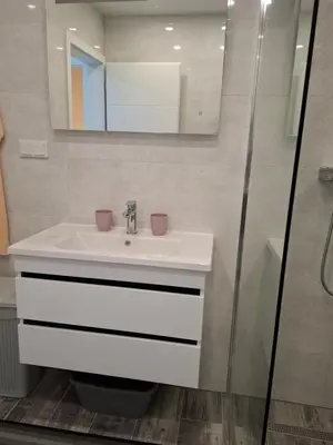 a bathroom with a white sink and a mirror at Apartman Ditka in Bihać