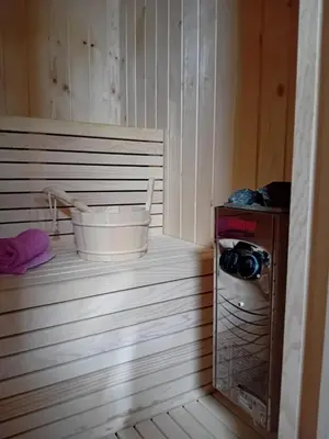 a sauna with a bucket and a washing machine at Gyps Vikendica with Swimming Pool and Sauna in Tuzla