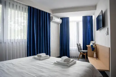 a hotel room with a bed with towels on it at Motel Brist in Zenica