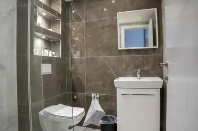 a bathroom with a toilet and a sink and a mirror at Motel Brist in Zenica