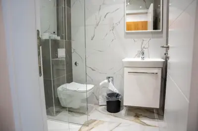 a bathroom with a toilet and a glass shower at Motel Brist in Zenica