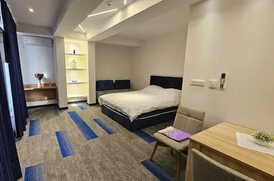 a small room with a bed and a desk and a chair at Motel Brist in Zenica