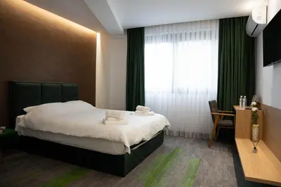 a hotel room with a bed and a window at Motel Brist in Zenica