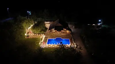 an overhead view of a pool with lights at night at Ranč Lipe in Orašje