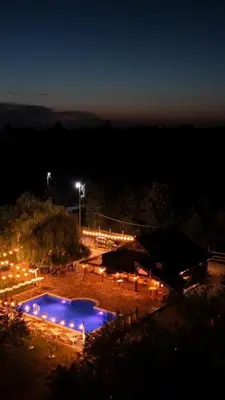 a pool with lights in a park at night at Ranč Lipe in Orašje