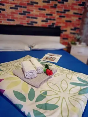 a bed with towels and flowers on top of it at Gyps Vikendica with Swimming Pool and Sauna 2 in Tuzla