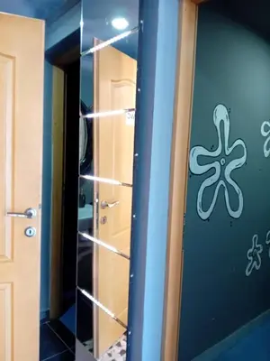 a room with a door with an octopus on the wall at Gyps Vikendica with Swimming Pool and Sauna 2 in Tuzla