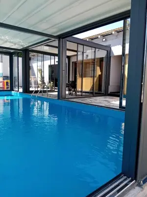 a swimming pool with a view of a house at Gyps Vikendica with Swimming Pool and Sauna 2 in Tuzla
