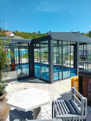a glass house with a pool in it at Gyps Vikendica with Swimming Pool and Sauna 2 in Tuzla