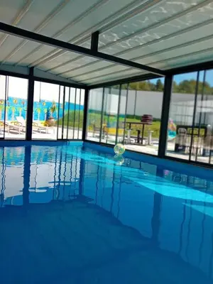 a swimming pool with a view of the water at Gyps Vikendica with Swimming Pool and Sauna 2 in Tuzla
