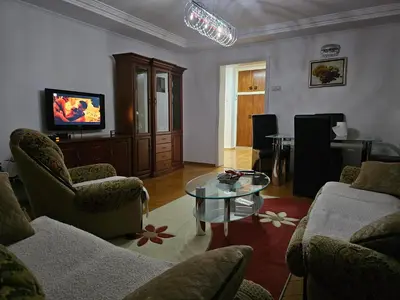a living room with couches and a table and a television at Ramonda Banja Luka in Banja Luka