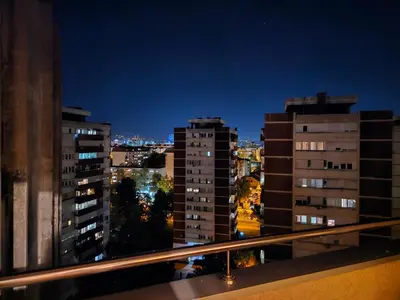 a view of a city at night from a balcony at Ramonda Banja Luka in Banja Luka