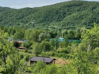 a house in the middle of a valley with a river at Kuća za odmor Villa Lana Bihać in Bihać