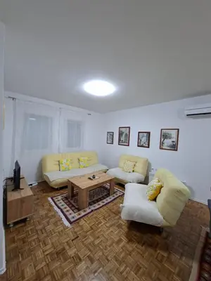 a living room with two couches and a coffee table at Apartmani E&A Jasmina Okanović in Gradačac