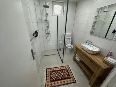 a bathroom with a shower and a sink and a toilet at Apartmani E&A Jasmina Okanović in Gradačac