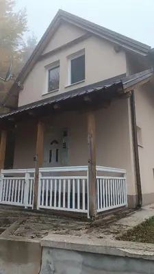 a house with a porch with a white fence at Mountain Home
