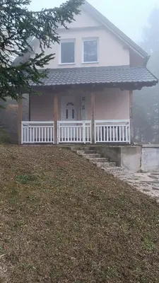 a house with a white fence and a porch at Mountain Home
