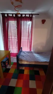 a bedroom with a bed and a window with a colorful floor at Mountain Home