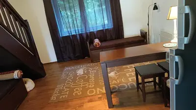 a living room with a desk and a table and a chair at Mountain Home
