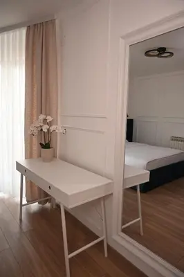 a mirror in a room with a bed and a table at Mas Motel in Bosanska Gradiška
