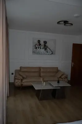 a living room with a couch and a table at Mas Motel in Bosanska Gradiška