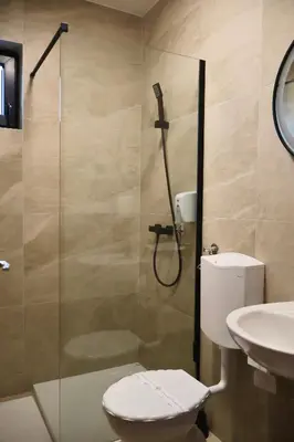 a bathroom with a shower and a toilet and a sink at Mas Motel in Bosanska Gradiška