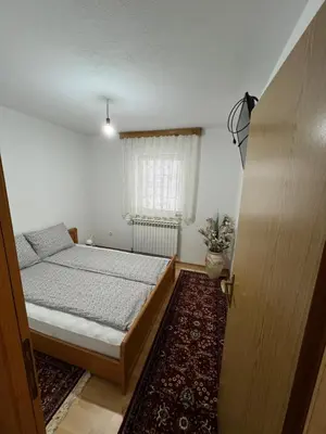 a bedroom with a bed and a window and a rug at Relax House