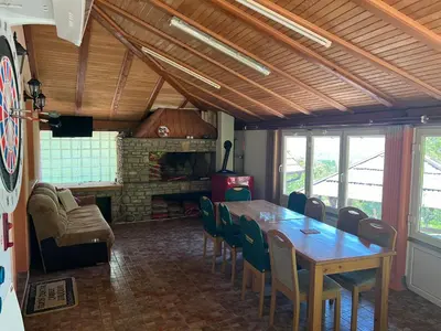 a dining room with a wooden table and chairs at Relax House