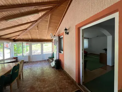 a living room with a table and a dining room at Relax House