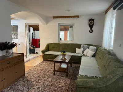 a living room with a green couch and a table at Relax House