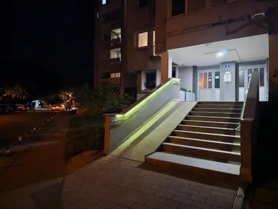 a set of stairs leading to a building at night at Ramonda Apartment Banja Luka in Banja Luka