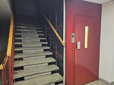a stairway with a red door next to a red door at Ramonda Apartment Banja Luka in Banja Luka