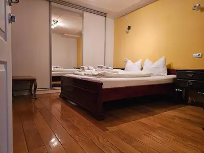 a bedroom with two beds and a large mirror at Ramonda Apartment Banja Luka in Banja Luka