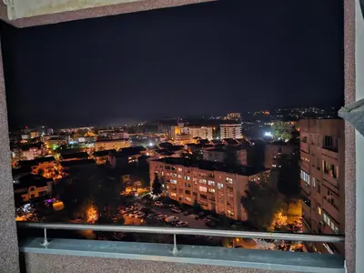 a view of a city at night from a window at Ramonda Apartment Banja Luka in Banja Luka
