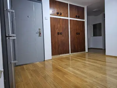 an empty room with wooden doors and wooden floors at Ramonda Apartment Banja Luka in Banja Luka
