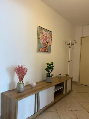 a living room with a wooden cabinet with flowers on it at A&N Apartments in Banja Luka